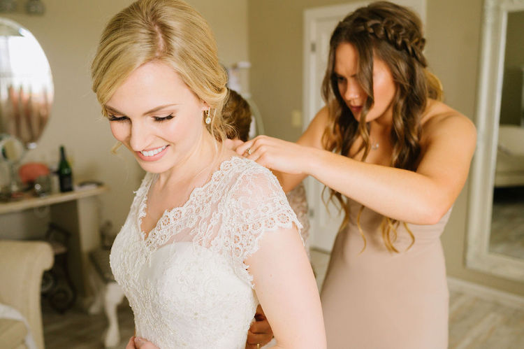 bride getting dressed short sleeve lace overlay - Loudoun County wedding Lisa Havard Events