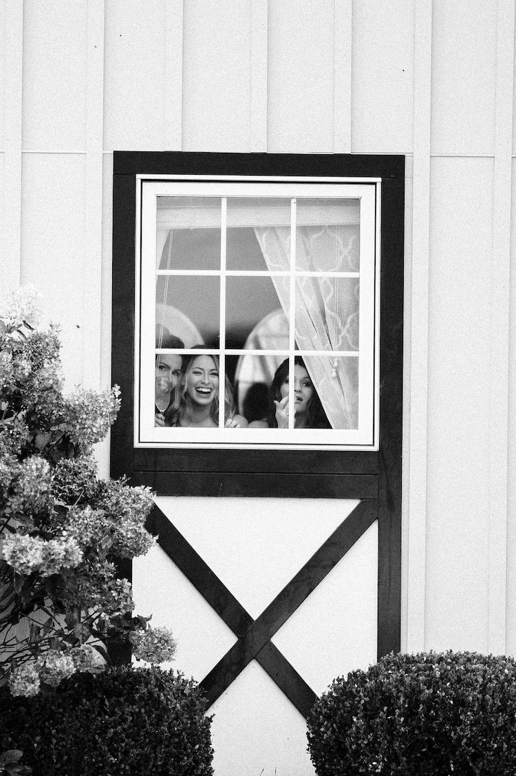 bridesmaids watch through the window - Loudoun County wedding Lisa Havard Events
