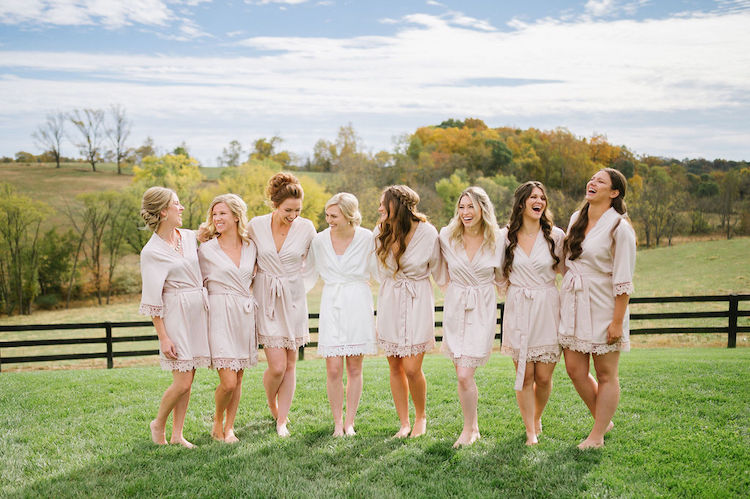 bridesmaids and bride in matching robes with countryside view neutral wedding - Loudoun County wedding Lisa Havard Events