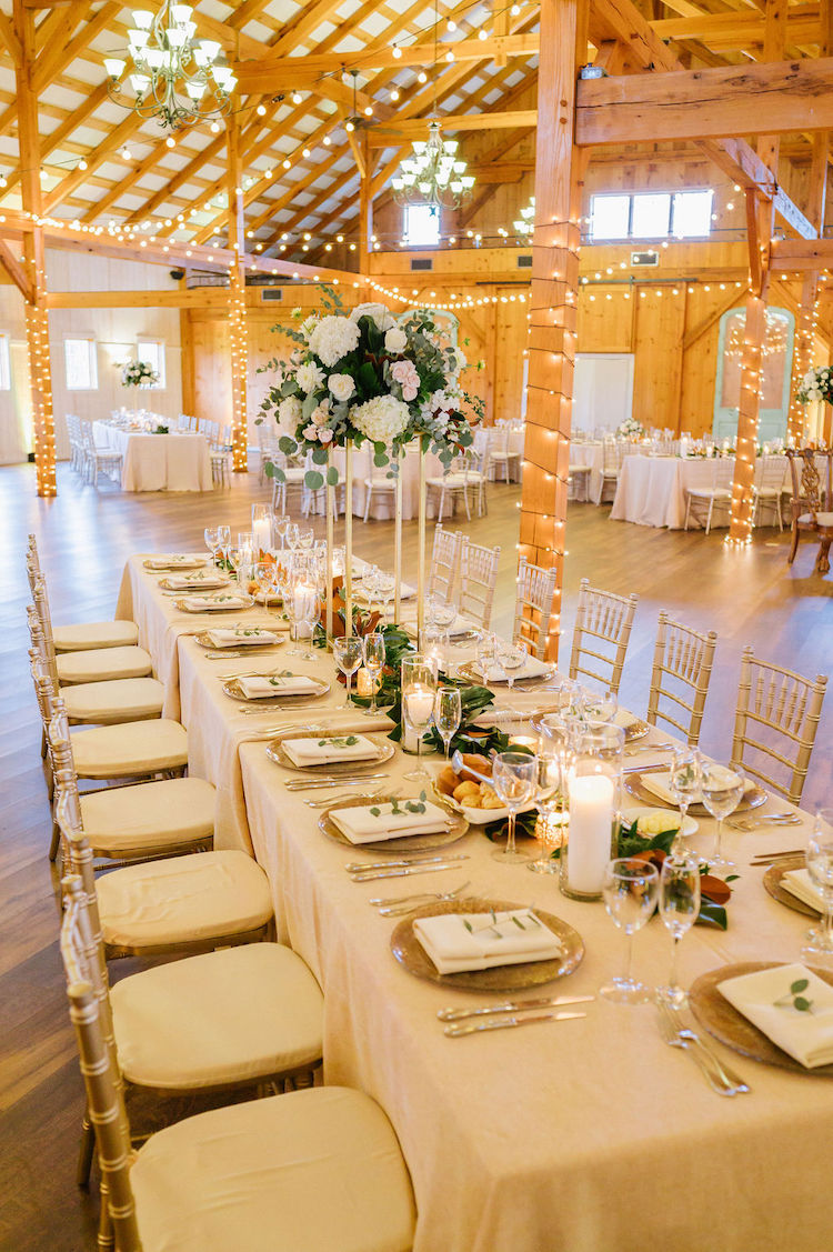 light, bright barn reception setup with beige tables and silver chairs neutral wedding - Loudoun County wedding Lisa Havard Events